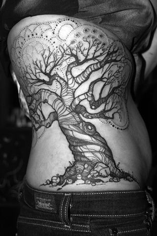 Black patchwork tree tattoo on back