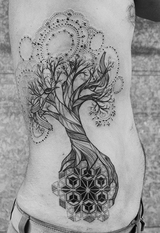 Black patchwork tree tattoo on ribs