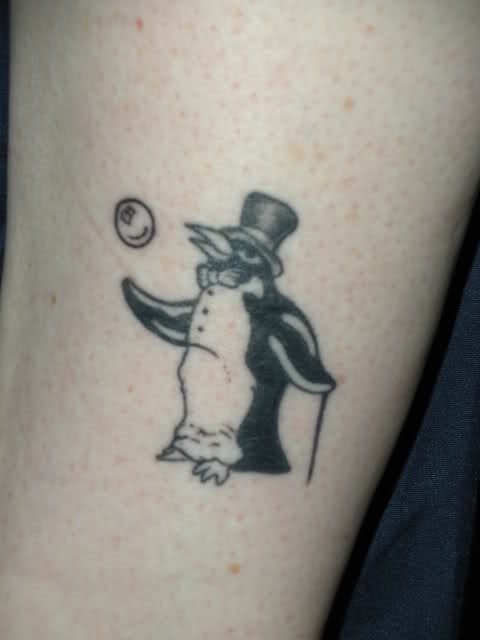 Black penguin tattoo in hat with bubble