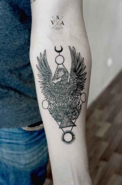 Black phoenix in alchemical style tattoo on arm