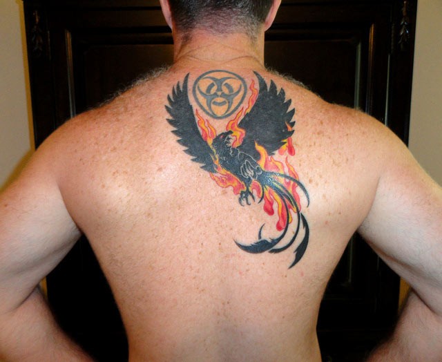 Black phoenix in flames of fire tattoo on back