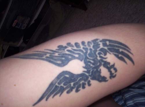 Black Phoenix tattoo on arm