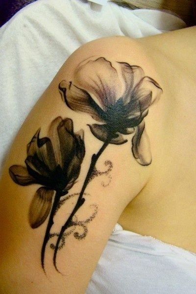 Black poppies tattoo on shoulder