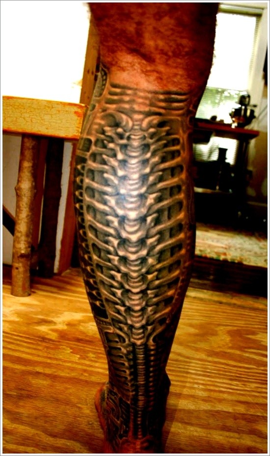 Black spine tattoo on leg