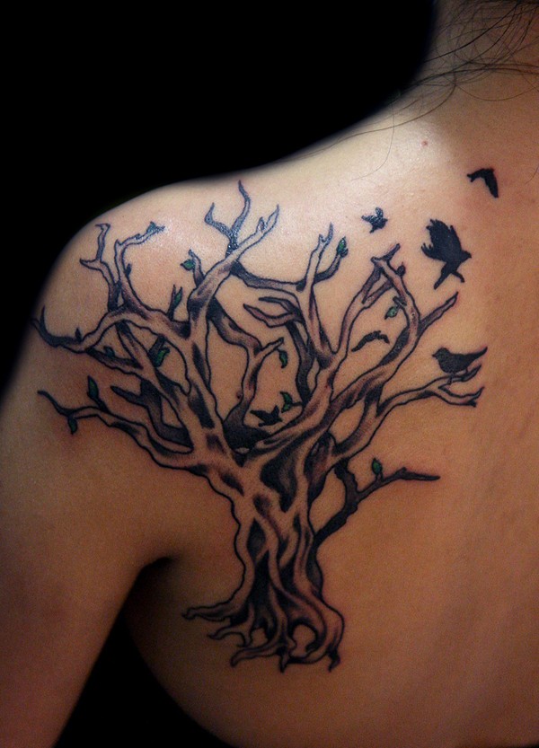 Black tree with birds tattoo on shoulder blade