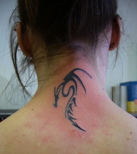 Black tribal dragon tattoo on neck