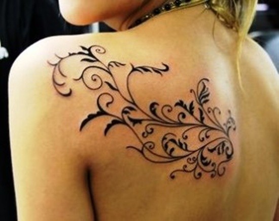 Black vine tattoo on shoulder blade