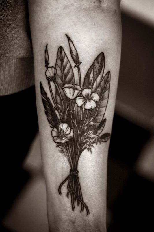 Black wildflowers forearm tattoo by Alice Carrier