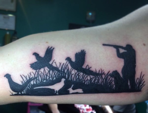 Blackwork style big arm tattoo of hunter shooting ducks