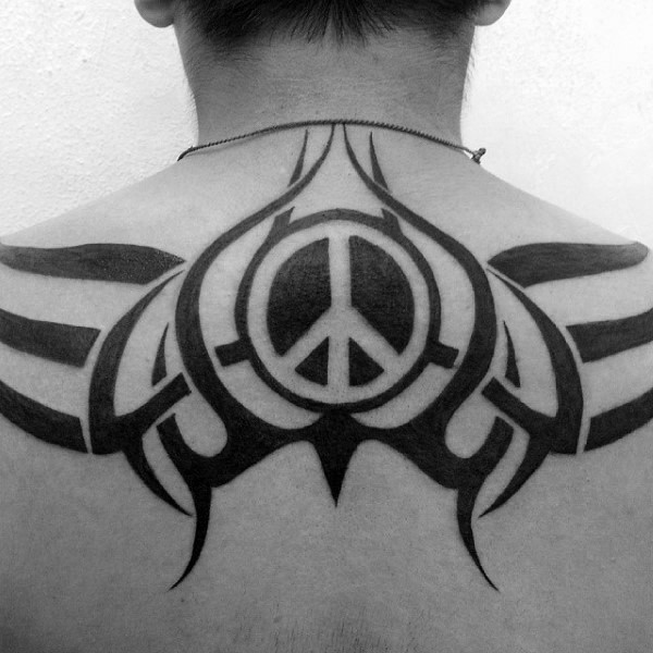 Blackwork style big back tattoo stylized with pacific symbol