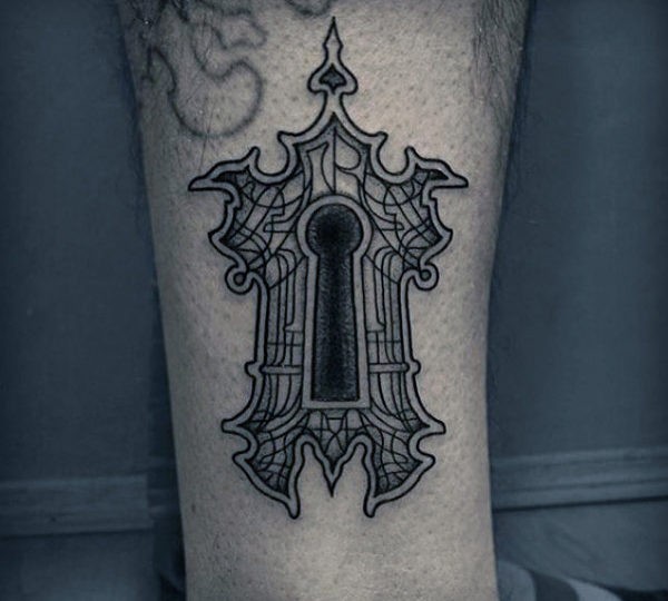 Blackwork style big leg tattoo of creepy key