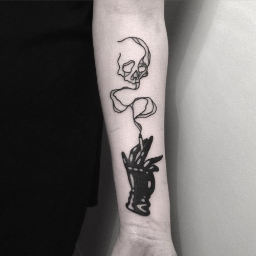 Blackwork style cool looking forearm tattoo of dark hand with smoke skull