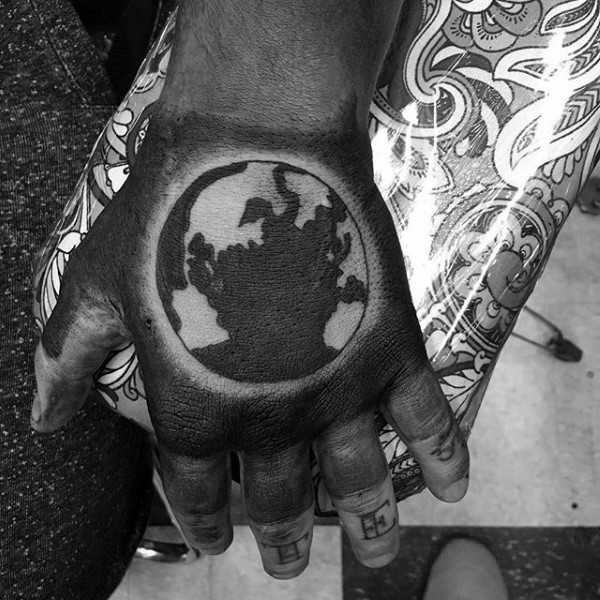 Blackwork style cool looking hand tattoo of big Earth planet
