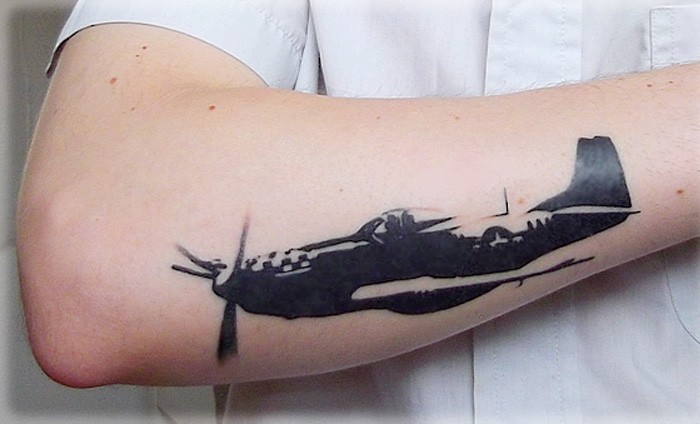 Blackwork style detailed arm tattoo of WW2 fighter plane