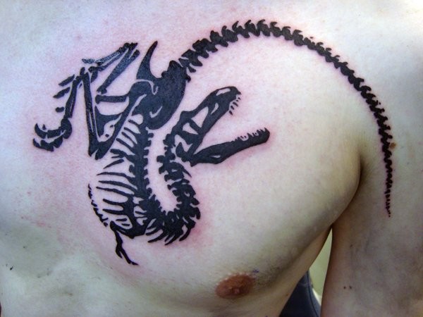 Blackwork style dinosaur skeleton tattoo on chest