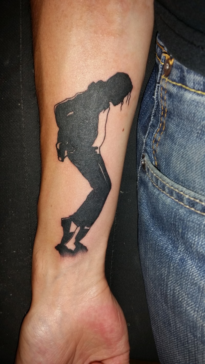 Blackwork style forearm tattoo of Michael Jackson silhouette