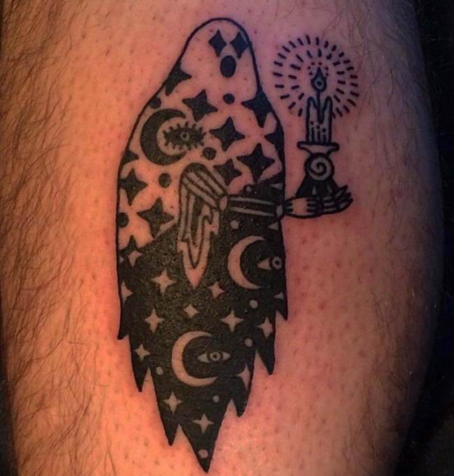 Blackwork style interesting looking ghost with candle tattoo on leg