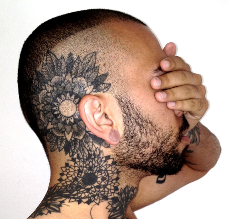 Blackwork style large head and neck tattoo of various flowers