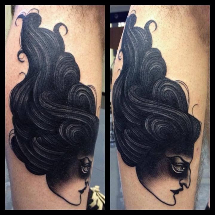 Blackwork style large leg tattoo of creepy woman head