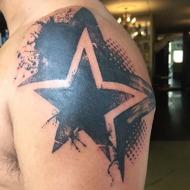 Blackwork style large shoulder tattoo of amazing star