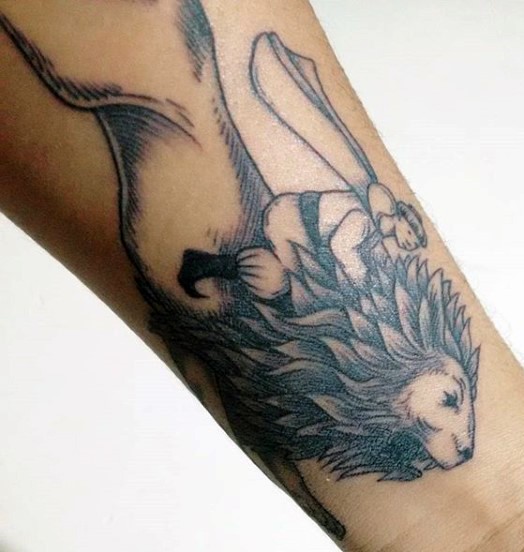 Blackwork style leg tattoo of man riding lion