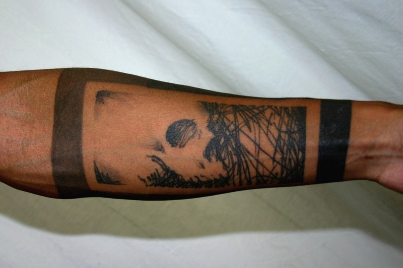 Blackwork style medium size forearm tattoo of jungles