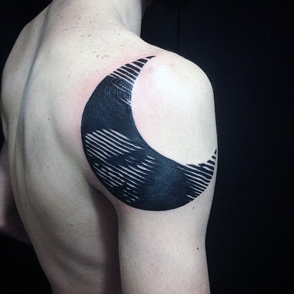 Blackwork style moon tattoo on shoulder with woman portrait