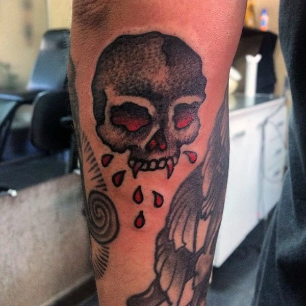 Bloody colored old school skull tattoo on arm
