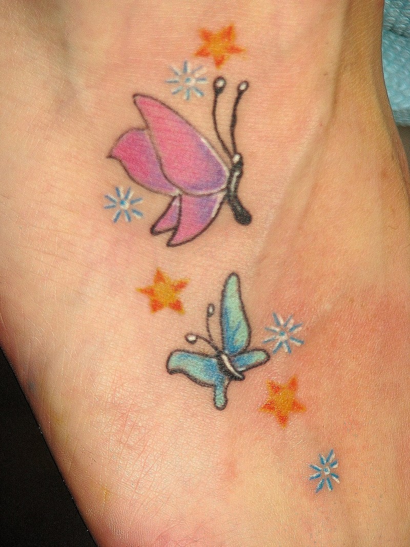 Blue and pink small butterfly tattoo with stars