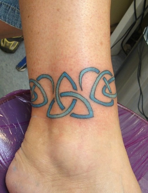 Blue celtic symbols band tattoo on ankle