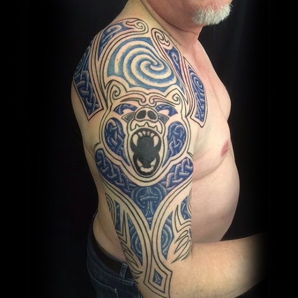 Blue colored shoulder tattoo of roaring bear with various ornaments