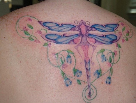 Blue dragonfly tattoo on back