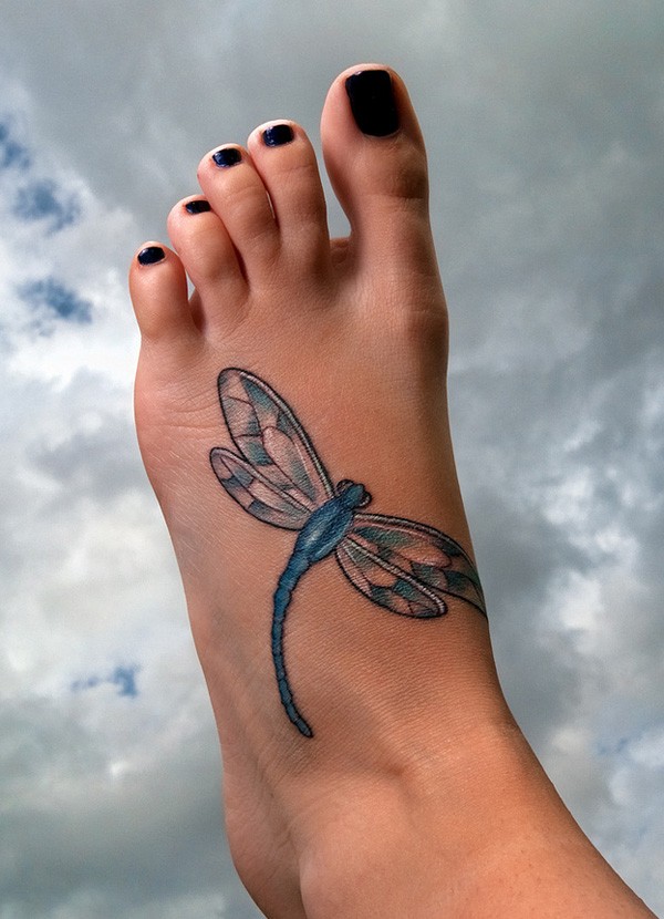 Blue dragonfly tattoo on leg