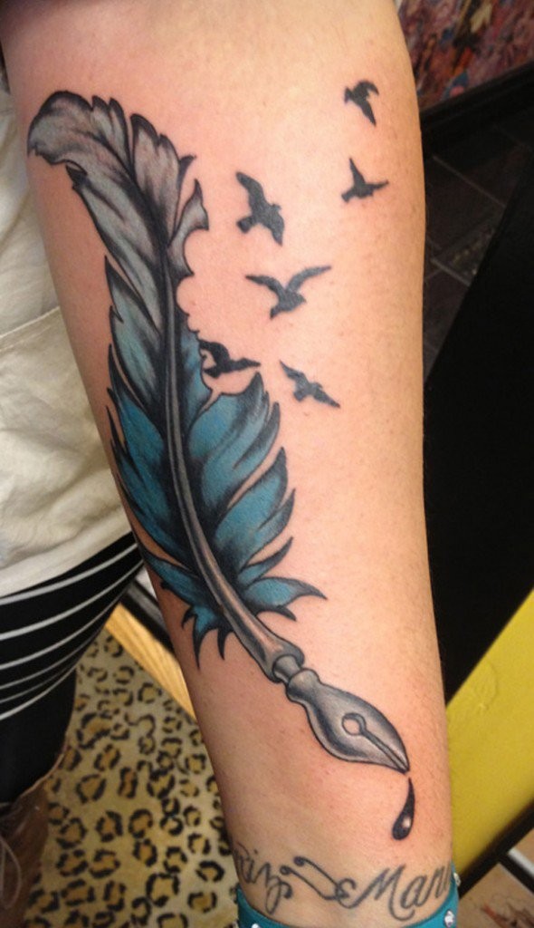 Blue feather bird tattoo on forearm