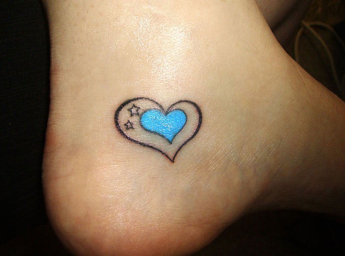 piccolo cuore blu con stelline tatuaggio su caviglia