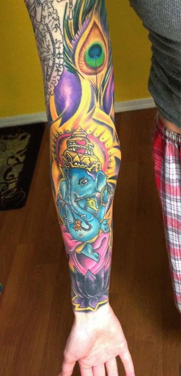 Tatuaggio colorato sul braccio il dio Ganesha & il loto
