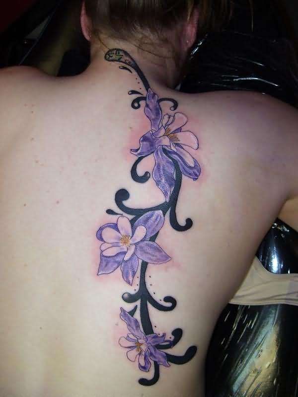 Blue orchids with black patterns tattoo on back