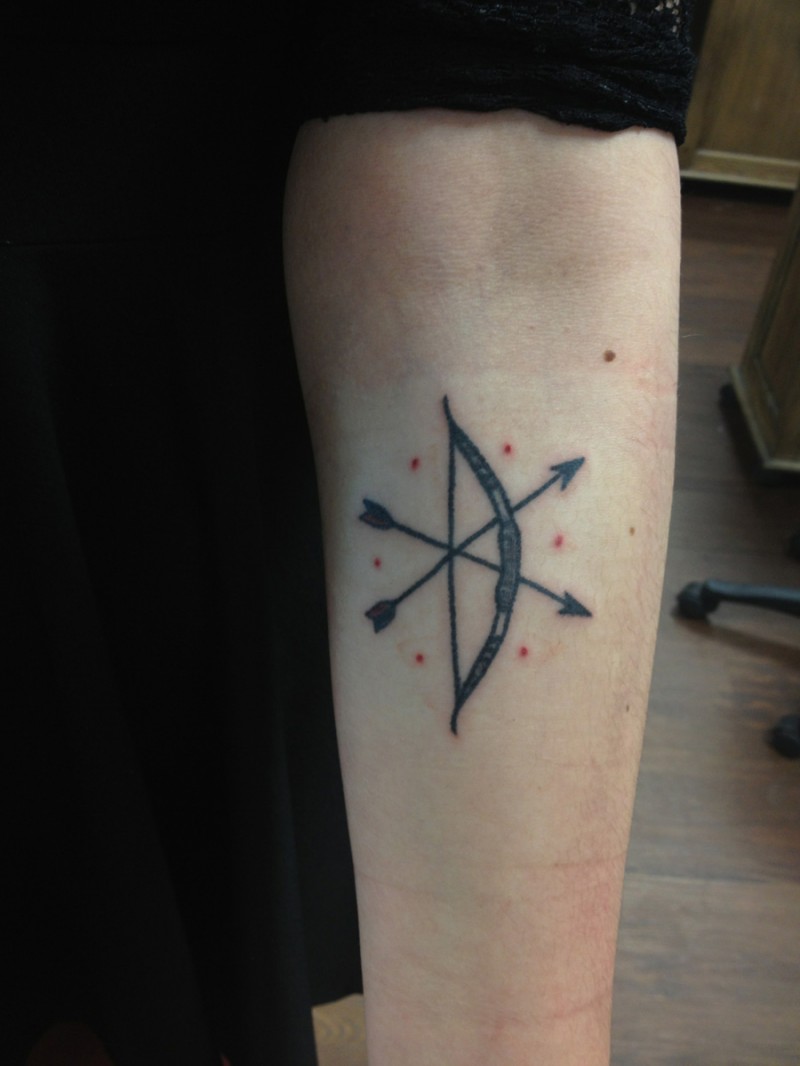 Bow and arrow tattoo with red dots