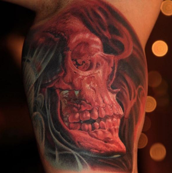 Breathtaking colored biceps tattoo of skull with smoke