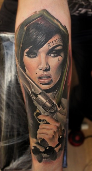 Breathtaking looking colored forearm tattoo of sexy woman with revolver