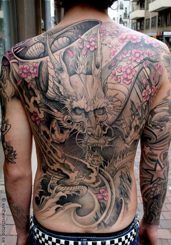 Breathtaking massive half colored Asian dragon with flowers tattoo on whole back