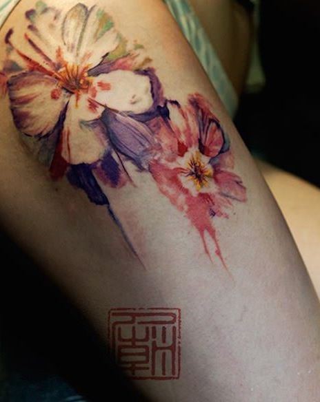 Breathtaking natural looking 3D flowers tattoo on thigh