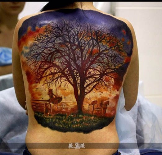 Breathtaking natural looking girl on tree swing back tattoo