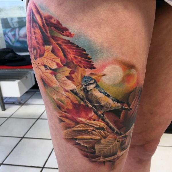 Breathtaking painted very realistic looking colored little bird with tree tattoo on thigh
