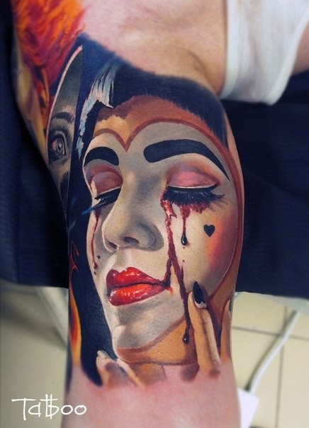 Breathtaking realism style colored biceps tattoo of crying bloody tears Joker woman face