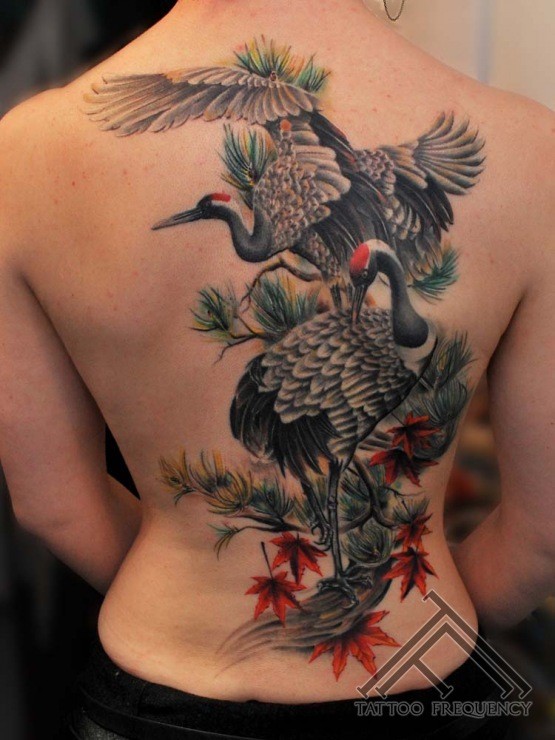 Breathtaking realism style colored birds tattoo on whole back with leaves
