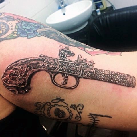 Breathtaking very detailed realism style antic pistol tattoo on shoulder