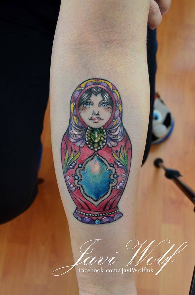 Bright colorful matryoshka with gems tattoo on forearm by Javi Wolf