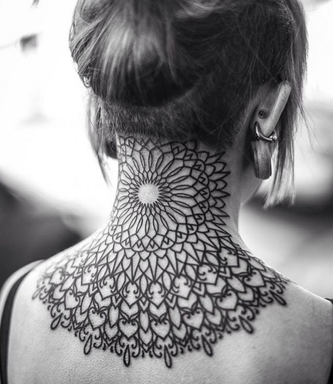 Brilliant detailed dark black ink designed ornament tattoo on neck and upper back in baroque style