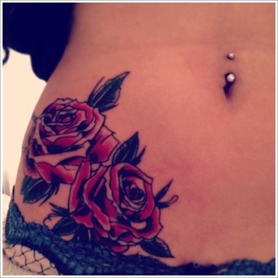 Brilliant red colored little roses tattoo on waist
